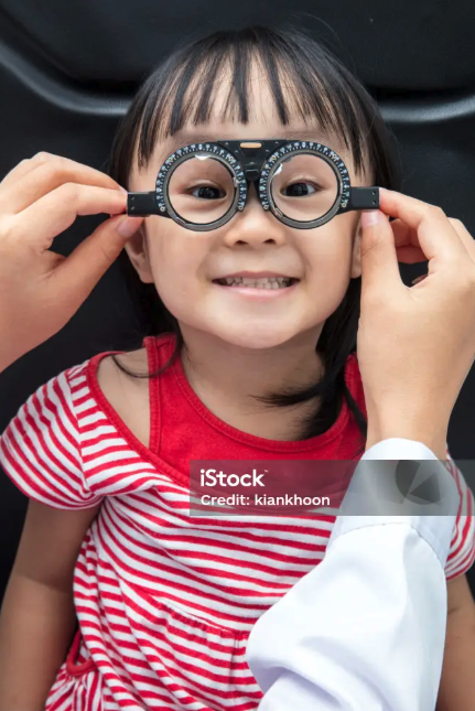 Photo: child trying on glasses